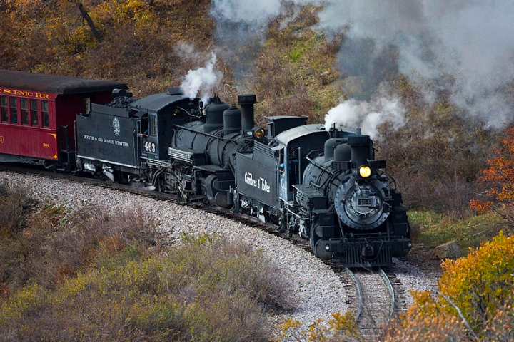 a train on a track with smoke coming out of it