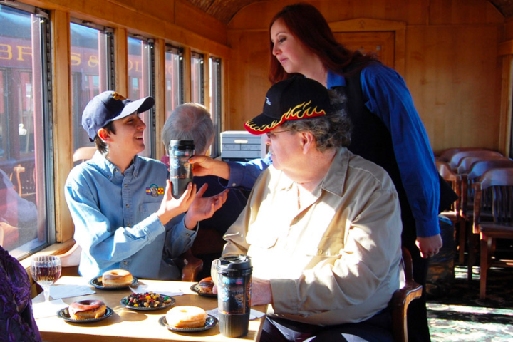 a group of people sitting at a table eating food