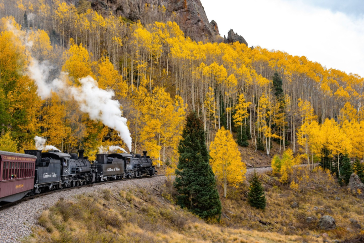 a train on a track with smoke coming out of it