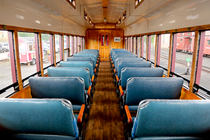 a train that is sitting on a chair in a room