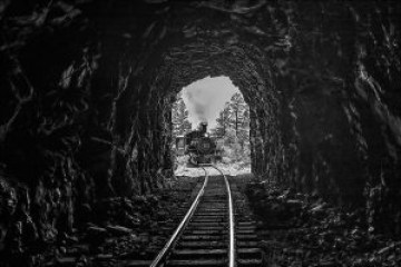 a tunnel with water in the background