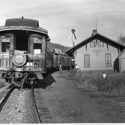 a train is parked on the side of a house