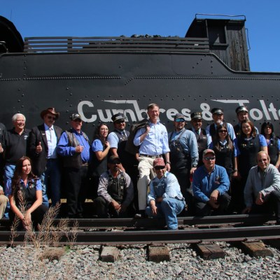 a group of people standing in front of a crowd posing for the camera