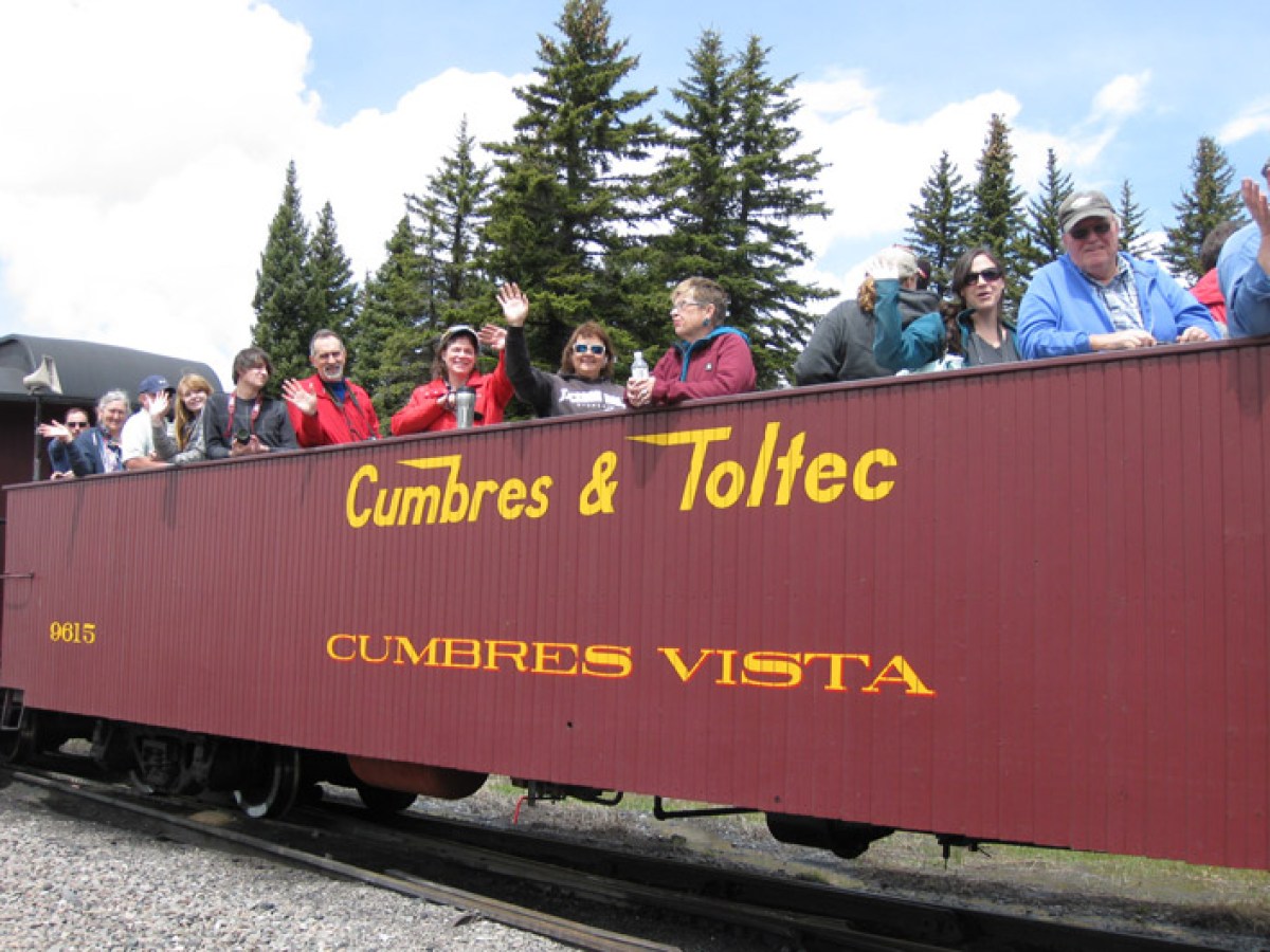 a group of people sitting on a train track