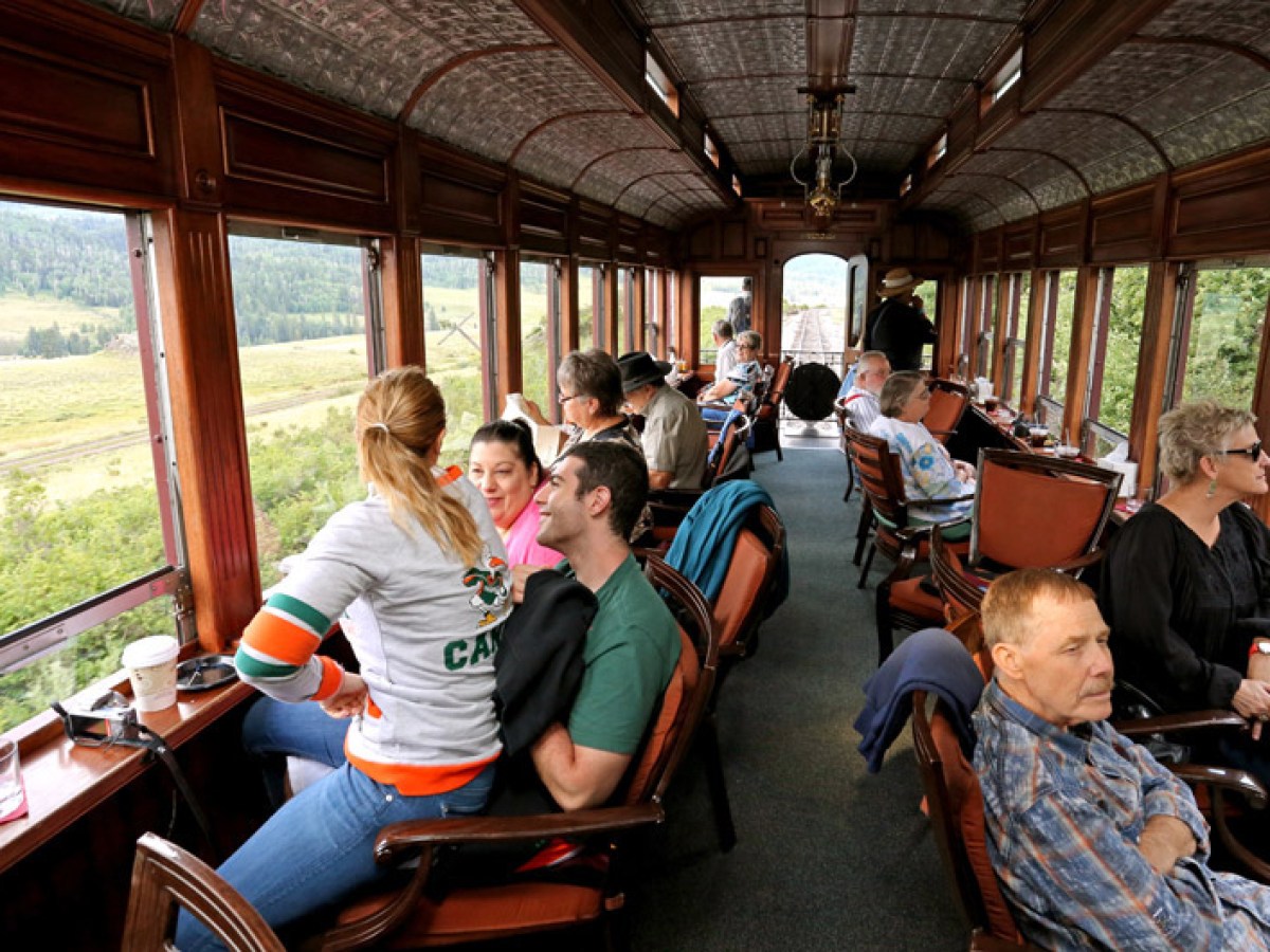 a group of people sitting at a table in front of a window