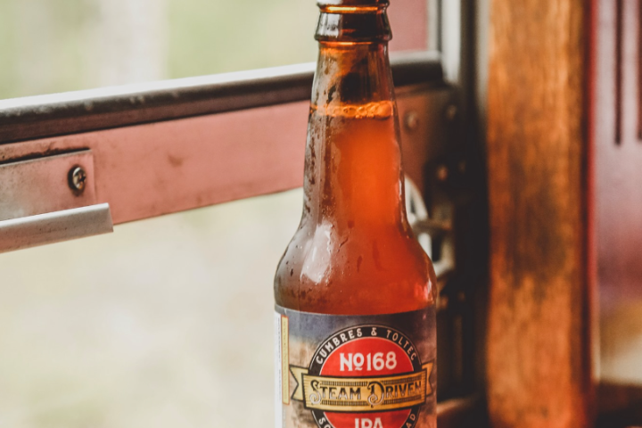 a bottle of wine sitting on top of a wooden table