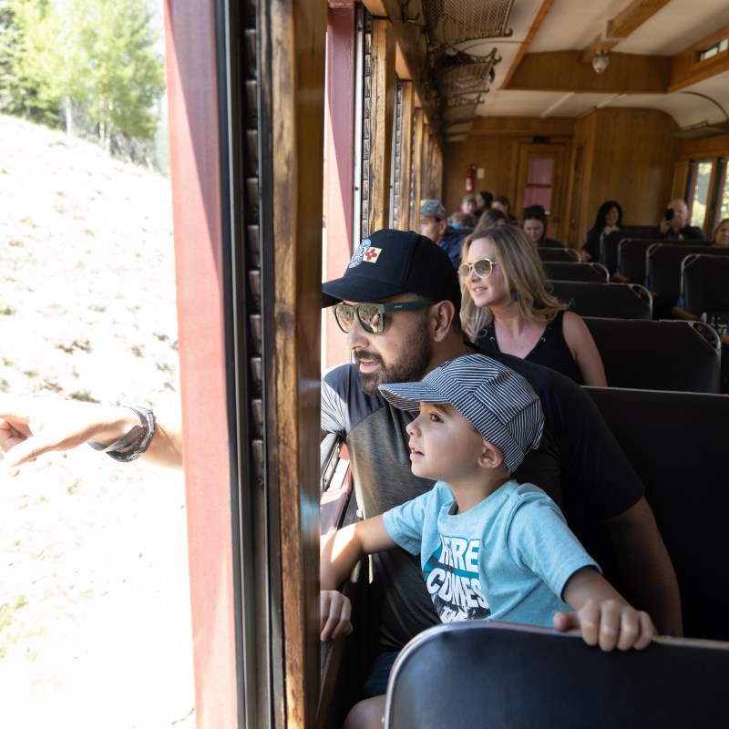 A family enjoying a train ride on the Cumbres & Toltec Scenic Railroad.