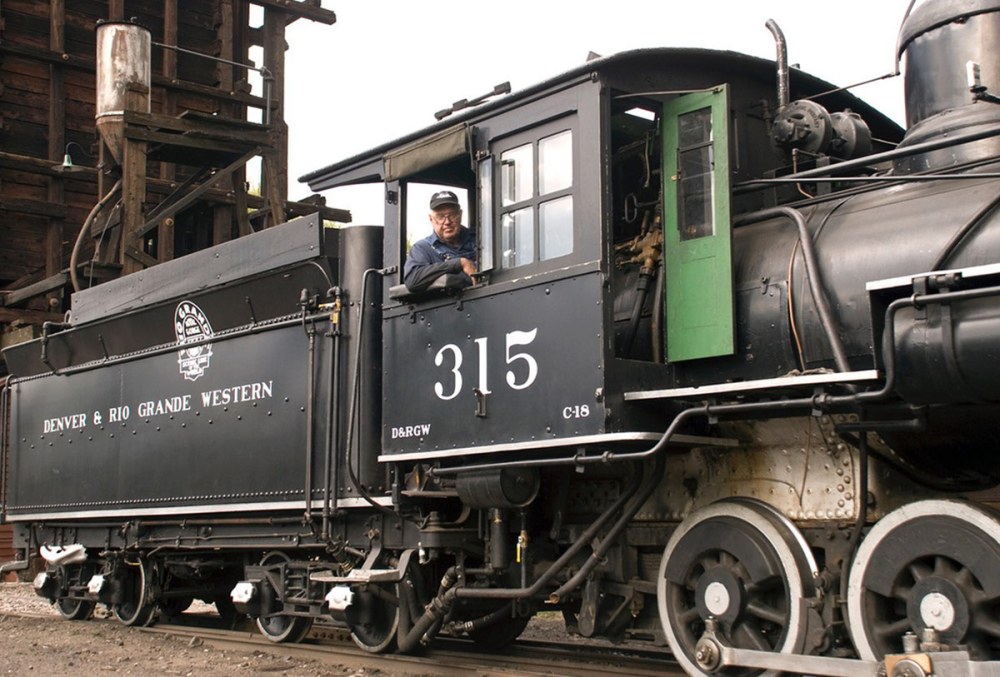 Steam locomotive 315 with a smiling engineer at the window.