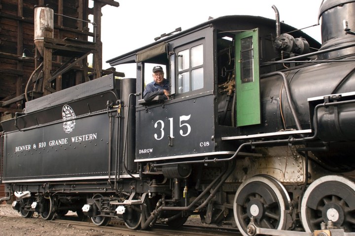 Steam locomotive 315 with a smiling engineer at the window.