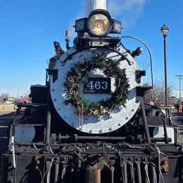Front view of steam locomotive with festive wreath and number 463 displayed.