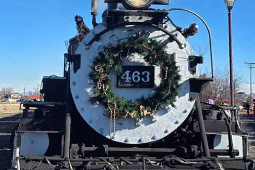 Front view of steam locomotive with festive wreath and number 463 displayed.